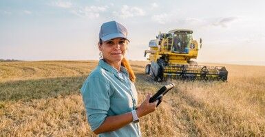 woman tablet hat farmland field tractor jpg