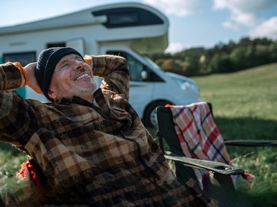 Older man leaning back relaxing outside