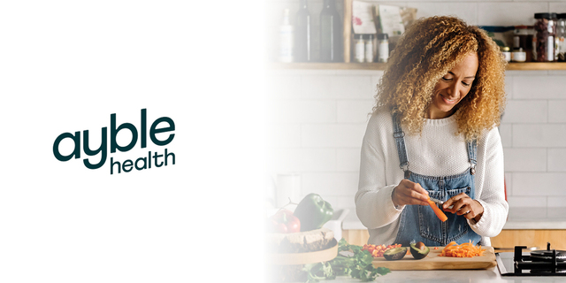 ayble health logo next a woman cutting up vegetables in her kitchen