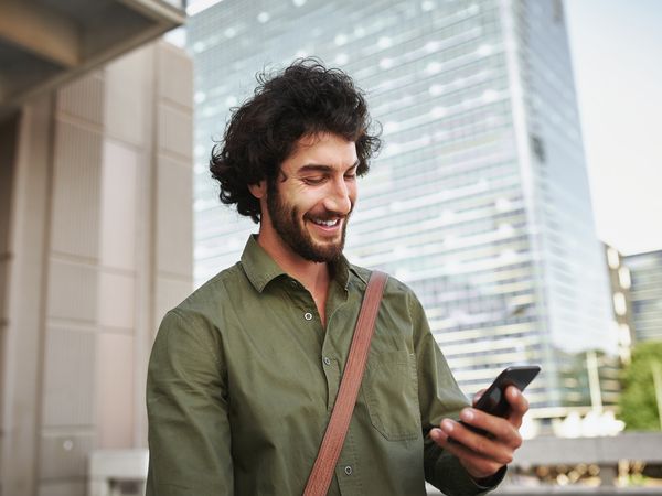 man smiling at phone