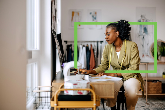 Seamstress working on her computer