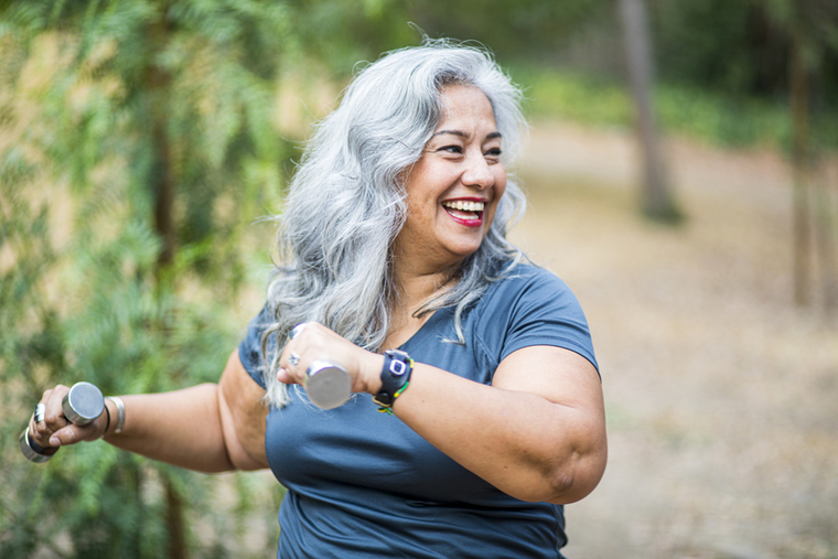 Smiling woman stretching outdoors