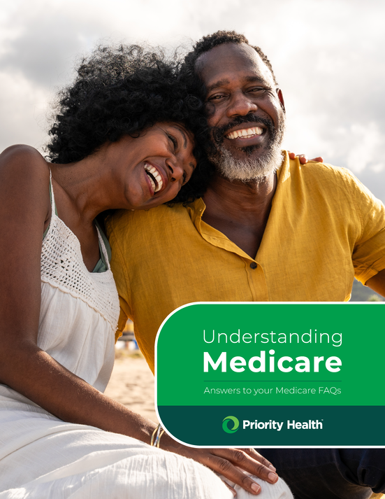 Cover image of Understanding Medicare guide with two smiling seniors