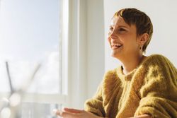 Smiling woman in yellow sweater 