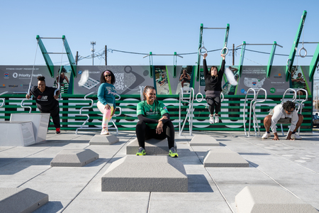 Group of five local women posing in action at a Priority Health Fitness Court in Benton Harbor, Michigan