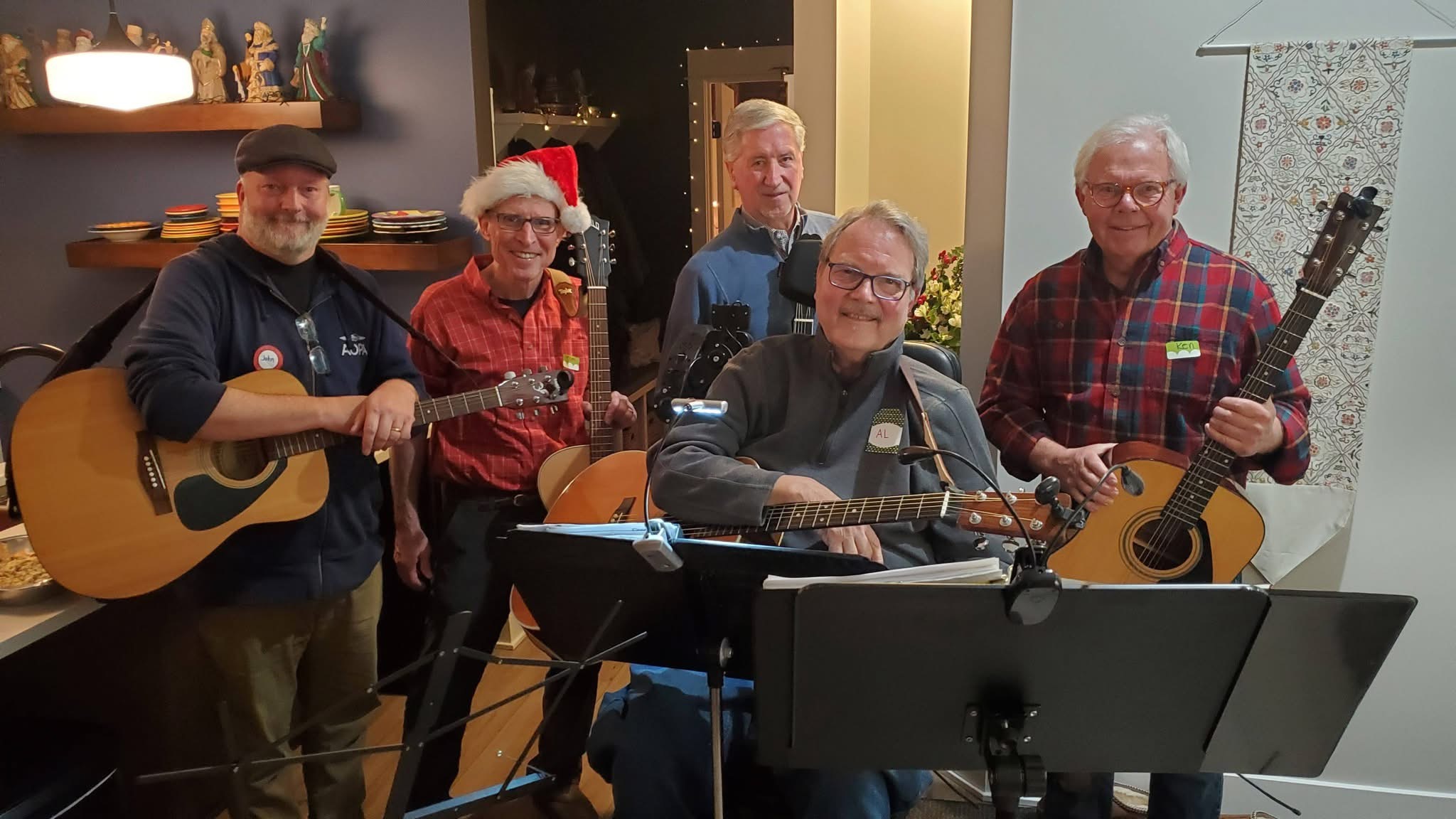 group of older men posing in front of music stands with their acoustic guitars