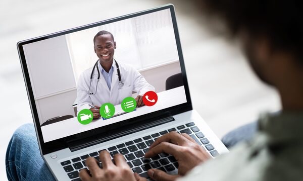 Patient speaking to their doctor during a virtual appointment on their laptop