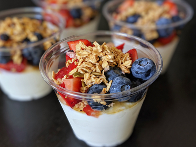 closeup of four blueberry, strawberry and oat parfaits