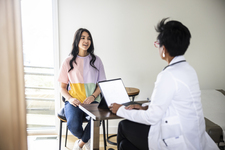 Young adult woman sitting in chair at provider office