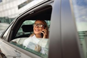 A woman looking out of a taxi window on the phone
