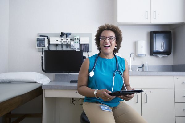 smiling provider in exam room