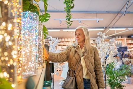 older woman shopping holiday decorations lights