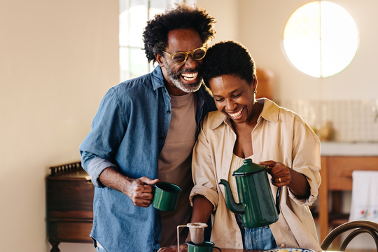 Smiling man and woman drinking coffee