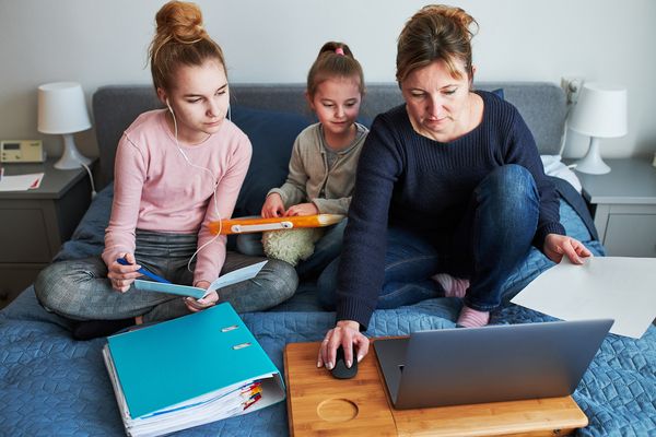 mom with two daughters looking at computer
