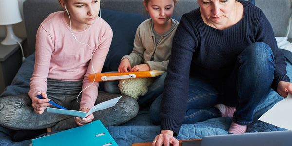 mom with two daughters looking at computer