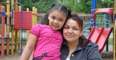 mom and daughter sitting on playground