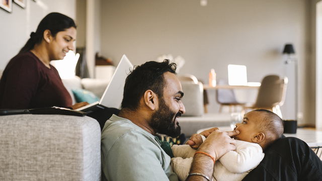 Dad sitting on the floor with a baby in his lap