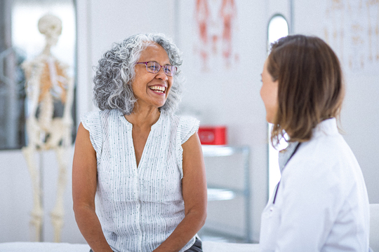 mature woman talking to her doctor