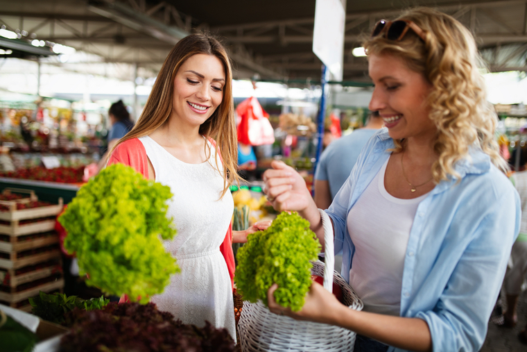 Women buying lettuce at farmer's market
