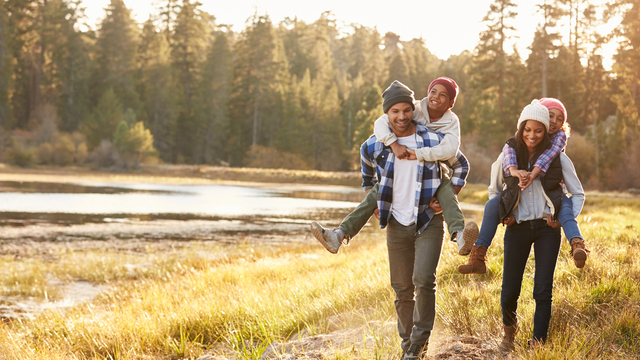 Family walking in the woods in the fall