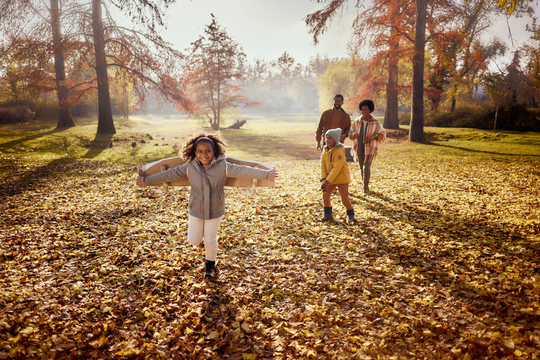 Family having fun in park during autumn