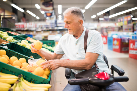 Man in a scooter shopping for produce