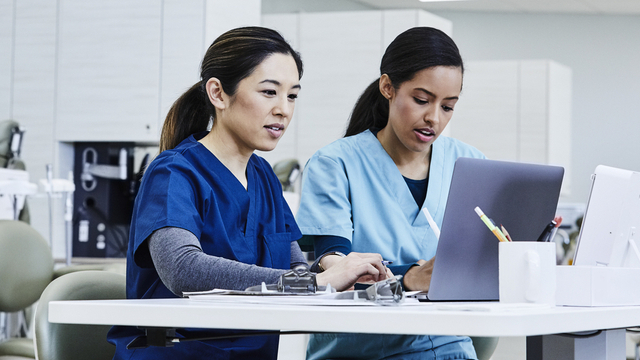 healthcare workers in lab on computer