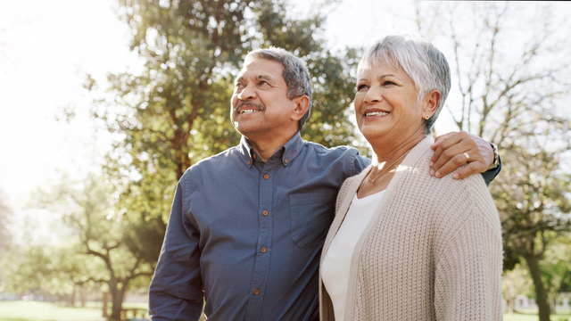 Older couple in side embrace on a sunny spring day 