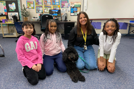 Priority Pups dog Meeka visiting students at Godwin Heights school