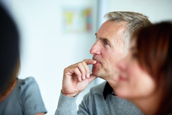 man in office meeting thinking about health coverage options